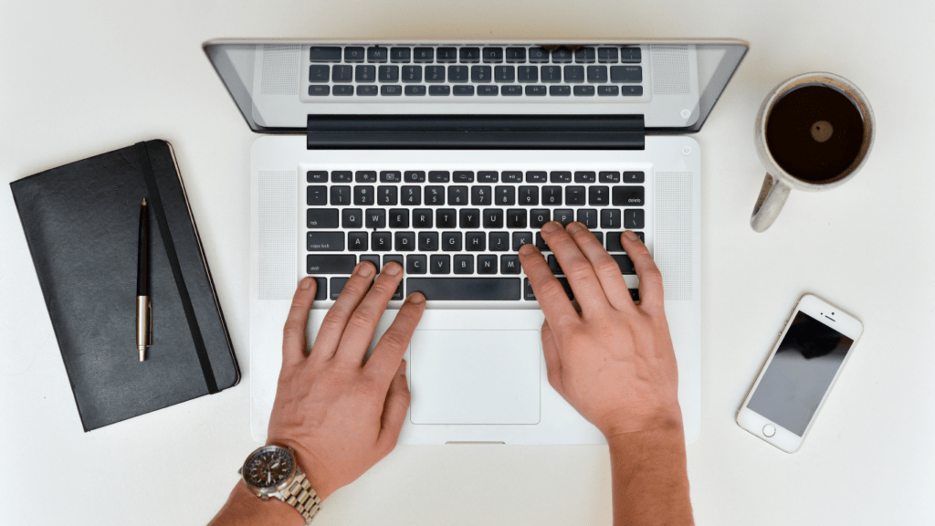 man writing article in his laptop