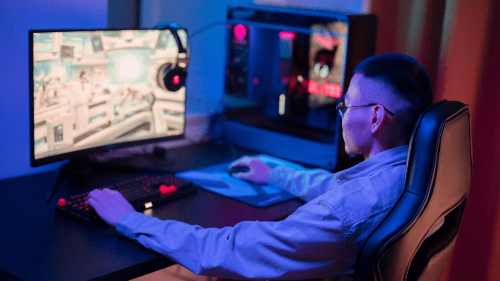 a person sitting in front of a computer playing video game