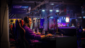 a person sitting at a desk in front of a computer screen