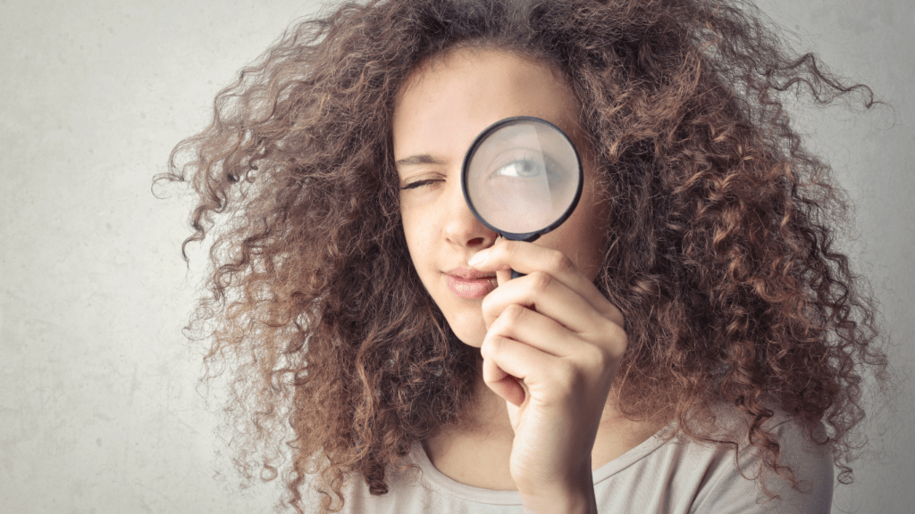 a person holding a magnifying glass