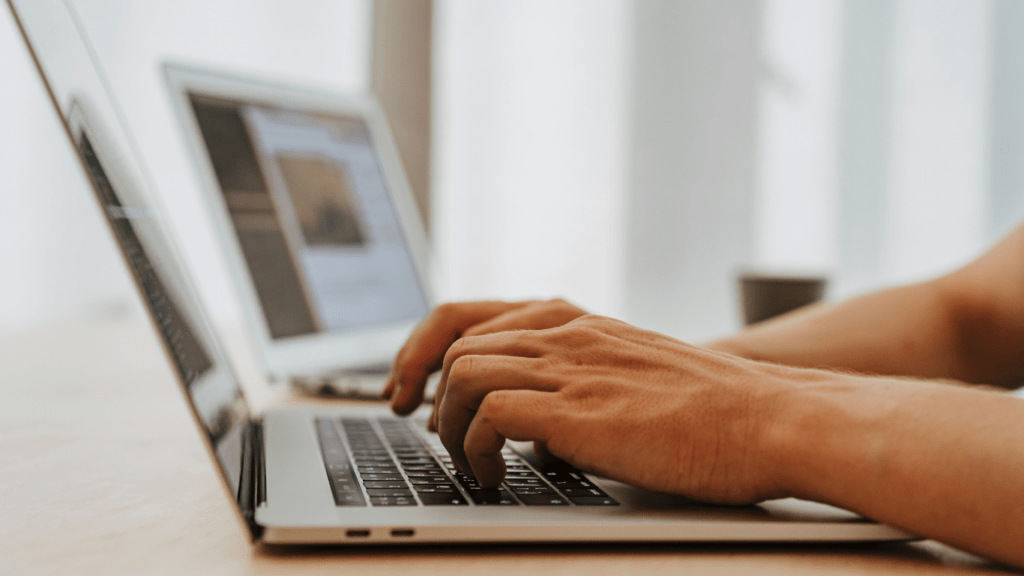 a person typing on a laptop computer