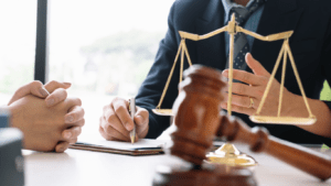 a person in a suit holding a gavel in front of a judge