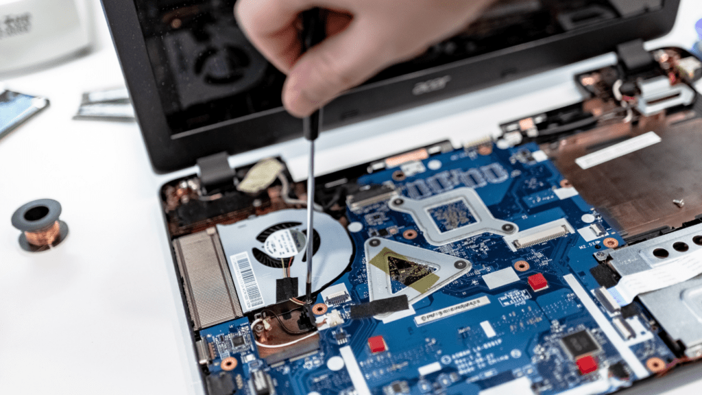 a person is repairing a laptop