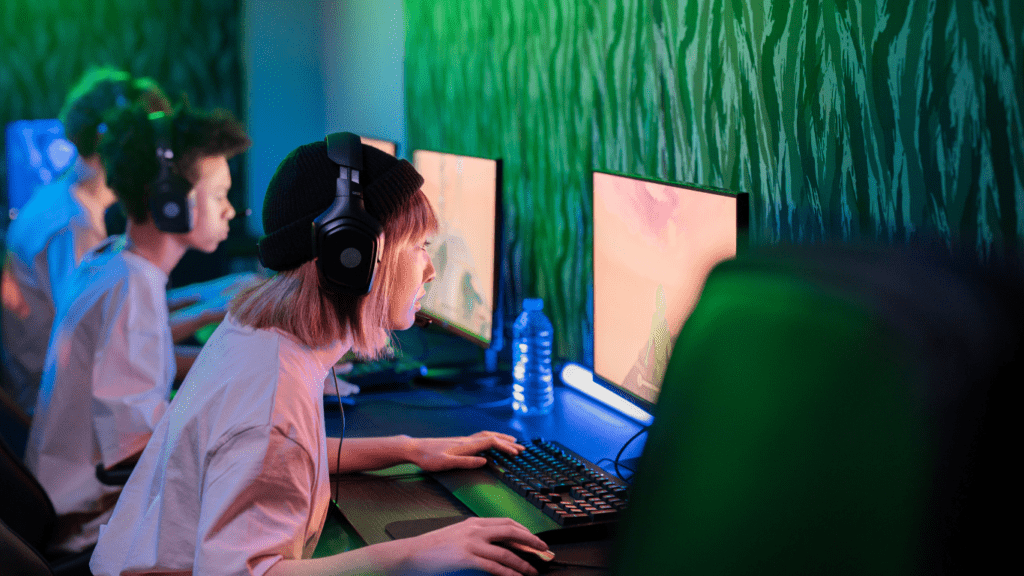 a group of people playing video games in a dark room