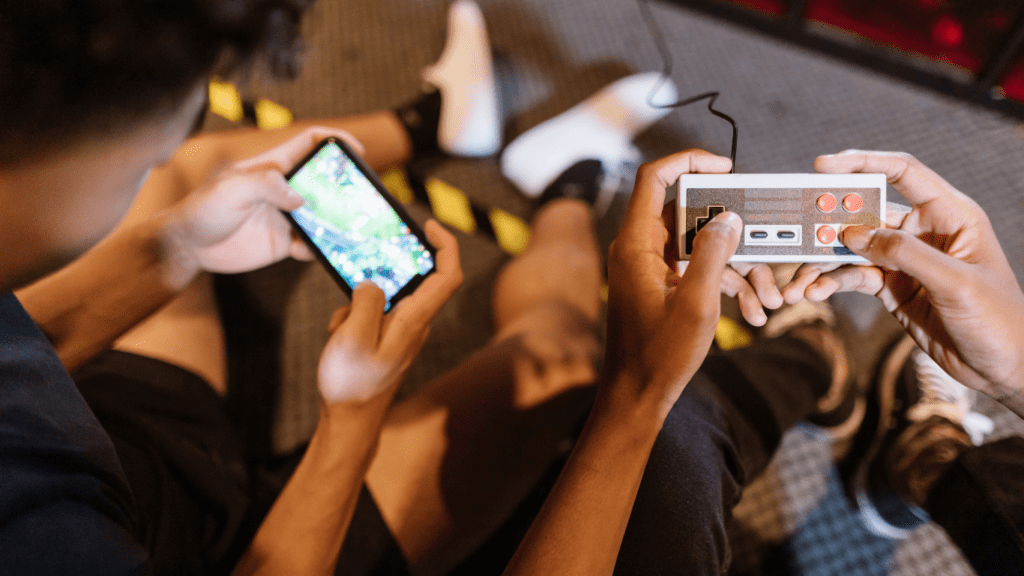 two people playing video games on a couch