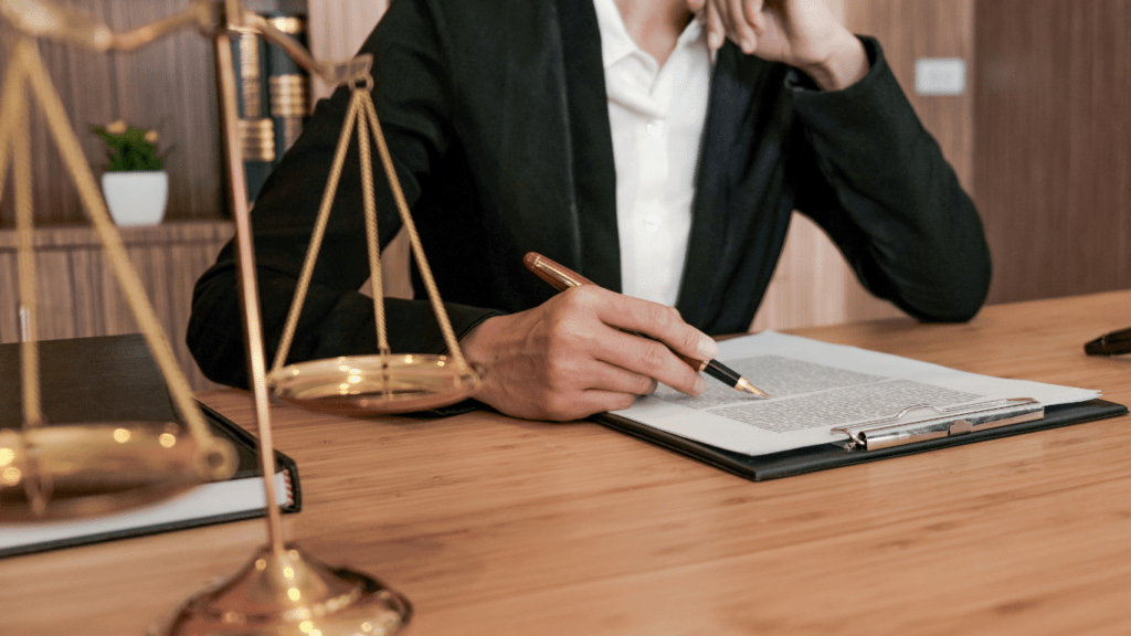 a person in a suit holding a gavel in front of a judge