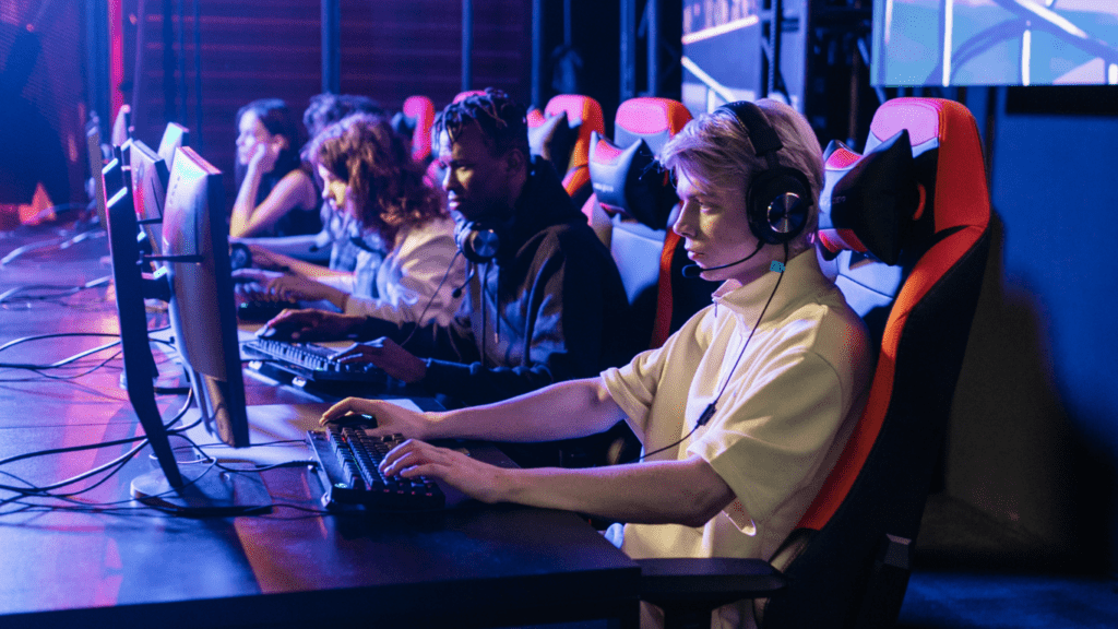 a person sitting in front of a computer playing video game