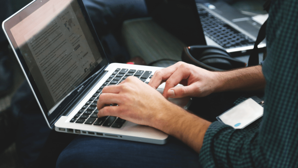 a person typing on a laptop computer